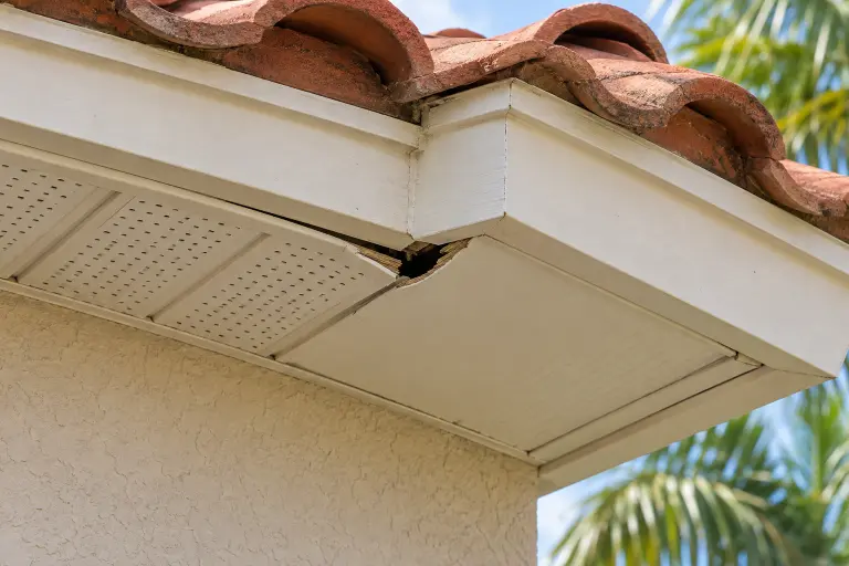 AI-generated example of a damaged opening at a tile-roof soffit corner
